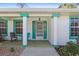 Welcoming front porch showcasing a stylish entrance with ample seating and decorative plants, enhancing curb appeal at 2631 Tomaso Rd, North Port, FL 34287
