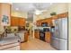 Spacious kitchen with wood cabinets, stainless steel appliances, and convenient breakfast bar at 2631 Tomaso Rd, North Port, FL 34287