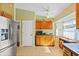Charming kitchen with wooden cabinets, stainless steel fridge and plentiful natural light at 2631 Tomaso Rd, North Port, FL 34287