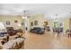 Open-concept living and dining area with tile flooring, a ceiling fan, and natural light, creating a spacious atmosphere at 2631 Tomaso Rd, North Port, FL 34287