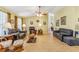 Bright living room with tile flooring, comfortable sofas, and ample lighting, offering a cozy and inviting space at 2631 Tomaso Rd, North Port, FL 34287