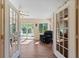 Inviting living room with a ceiling fan, hardwood floors, and sliding glass doors to outside at 2631 Tomaso Rd, North Port, FL 34287