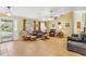 Spacious living room with tile flooring, comfortable seating arrangements, and ample natural light at 2631 Tomaso Rd, North Port, FL 34287