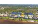 Aerial view showcasing waterfront properties with lush landscaping, community pond, and inviting neighborhood appeal at 2917 Mill Creek Rd, Port Charlotte, FL 33953