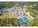 Aerial view of the community clubhouse, swimming pool, tennis courts, and convenient parking at 2917 Mill Creek Rd, Port Charlotte, FL 33953