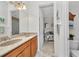 Bathroom showcasing a double vanity with a granite countertop leading to bedroom at 2917 Mill Creek Rd, Port Charlotte, FL 33953