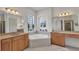 Luxurious bathroom with double sinks, soaking tub, and serene decor at 2917 Mill Creek Rd, Port Charlotte, FL 33953