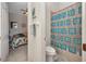 Bathroom view into the bedroom with tiled shower behind the toilet at 2917 Mill Creek Rd, Port Charlotte, FL 33953