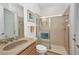 Clean bathroom with a granite countertop, tiled shower, and beach-themed decor at 2917 Mill Creek Rd, Port Charlotte, FL 33953