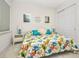 Bright bedroom features a colorful bedspread and nautical decor for a beachy feel at 2917 Mill Creek Rd, Port Charlotte, FL 33953