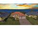 Stunning waterfront home boasts lush landscaping, a brick driveway, and an inviting three-car garage at 2917 Mill Creek Rd, Port Charlotte, FL 33953