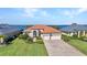 Stunning waterfront home with a tile roof, mature landscaping, and a spacious front lawn at 2917 Mill Creek Rd, Port Charlotte, FL 33953