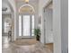 Inviting foyer features tile flooring, a decorative rug, and a transom window above the front door at 2917 Mill Creek Rd, Port Charlotte, FL 33953