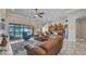 Open concept living area with waterfront views, a cozy leather sofa, and easy access to the kitchen at 2917 Mill Creek Rd, Port Charlotte, FL 33953