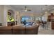 Spacious living room features tile flooring, a large leather sofa, and stunning waterfront views at 2917 Mill Creek Rd, Port Charlotte, FL 33953