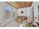 Comfortable living room boasts wood ceiling, arched windows, and cozy seating at 2917 Mill Creek Rd, Port Charlotte, FL 33953