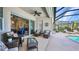 Covered patio featuring comfortable seating and access to the pool area at 2917 Mill Creek Rd, Port Charlotte, FL 33953