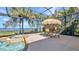Relaxing screened-in pool area with a hot tub and an outdoor dining set at 2917 Mill Creek Rd, Port Charlotte, FL 33953