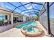 Screened in pool and hot tub overlooking beautiful waterway surrounded by patio furniture at 2917 Mill Creek Rd, Port Charlotte, FL 33953