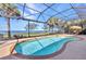 Beautiful screened pool area with a spa and view of the water at 2917 Mill Creek Rd, Port Charlotte, FL 33953