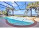 Screened in pool and hot tub overlooking beautiful waterway with palm trees at 2917 Mill Creek Rd, Port Charlotte, FL 33953