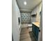 Bathroom with vinyl floors and blue vanity at 3308 Pinetree St, Port Charlotte, FL 33952