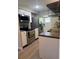 Efficient kitchen equipped with stainless steel appliances and light cabinetry at 3308 Pinetree St, Port Charlotte, FL 33952