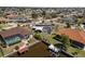 Beautiful aerial view of waterfront homes, including a private dock, screened pool, and lush landscaping at 4279 Harbor Blvd, Port Charlotte, FL 33952