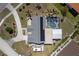 Aerial view of the home showcasing the solar panels, screened pool, and landscaping at 4279 Harbor Blvd, Port Charlotte, FL 33952