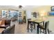 Bright and open dining area connected to the living room with kitchen barstool seating at 4279 Harbor Blvd, Port Charlotte, FL 33952