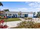 Inviting single-story home boasting a colorful exterior, a well-manicured lawn, and cozy front porch at 4279 Harbor Blvd, Port Charlotte, FL 33952