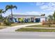 Charming blue home with manicured lawn, covered porch, and inviting curb appeal at 4279 Harbor Blvd, Port Charlotte, FL 33952