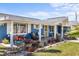 Charming blue home with covered porch, lush landscaping, and inviting curb appeal at 4279 Harbor Blvd, Port Charlotte, FL 33952