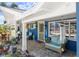 Charming front porch with brick flooring and blue decor, perfect for relaxing at 4279 Harbor Blvd, Port Charlotte, FL 33952