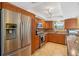 Bright kitchen features stainless steel appliances, light brown cabinetry, and tile flooring at 4279 Harbor Blvd, Port Charlotte, FL 33952