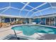 Wonderful screened-in pool area with spa, dining space, and covered lounge at 4279 Harbor Blvd, Port Charlotte, FL 33952