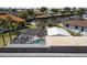 Aerial view of a home with a screened pool, solar panels and water access at 4279 Harbor Blvd, Port Charlotte, FL 33952