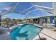 Sparkling screened-in pool, comfortable lounge area and lush landscaping at 4279 Harbor Blvd, Port Charlotte, FL 33952