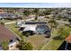 Aerial view of the screened pool with outdoor living space and solar panels on the roof of this home at 4279 Harbor Blvd, Port Charlotte, FL 33952