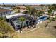 Aerial view of a screened pool with palm trees and landscaping in the backyard of this charming home at 4279 Harbor Blvd, Port Charlotte, FL 33952