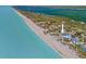 Majestic oceanfront house with direct beach access, surrounded by lush, tropical landscapes at 6112 Gnarled Oak Dr, Englewood, FL 34223