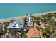 Stunning aerial view of a coastal home featuring a private pool and immediate beach access at 6112 Gnarled Oak Dr, Englewood, FL 34223