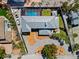 Drone shot showcases a beautiful single-Gathering home with backyard pool and driveway, surrounded by lush greenery at 6112 Gnarled Oak Dr, Englewood, FL 34223