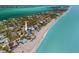 Aerial view showcasing the home's prime beachfront location with stunning ocean views and lush surroundings at 6112 Gnarled Oak Dr, Englewood, FL 34223