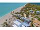 Breathtaking aerial view of a beachfront home with a private pool and easy access to the pristine beach at 6112 Gnarled Oak Dr, Englewood, FL 34223