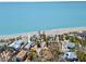 Picturesque aerial view of a coastal home and beach. Enjoy stunning ocean views from your property at 6112 Gnarled Oak Dr, Englewood, FL 34223
