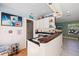 Wet bar area with white cabinets, a dark countertop, and unique coastal decorations at 6112 Gnarled Oak Dr, Englewood, FL 34223
