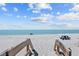 Scenic beach view with picnic table and chairs on a sunny day at 6112 Gnarled Oak Dr, Englewood, FL 34223