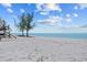 Beautiful beach scene with serene water, light sand, and clear skies at 6112 Gnarled Oak Dr, Englewood, FL 34223