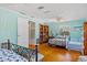 Spacious bedroom featuring hardwood floors, closet, and comfortable bedding at 6112 Gnarled Oak Dr, Englewood, FL 34223